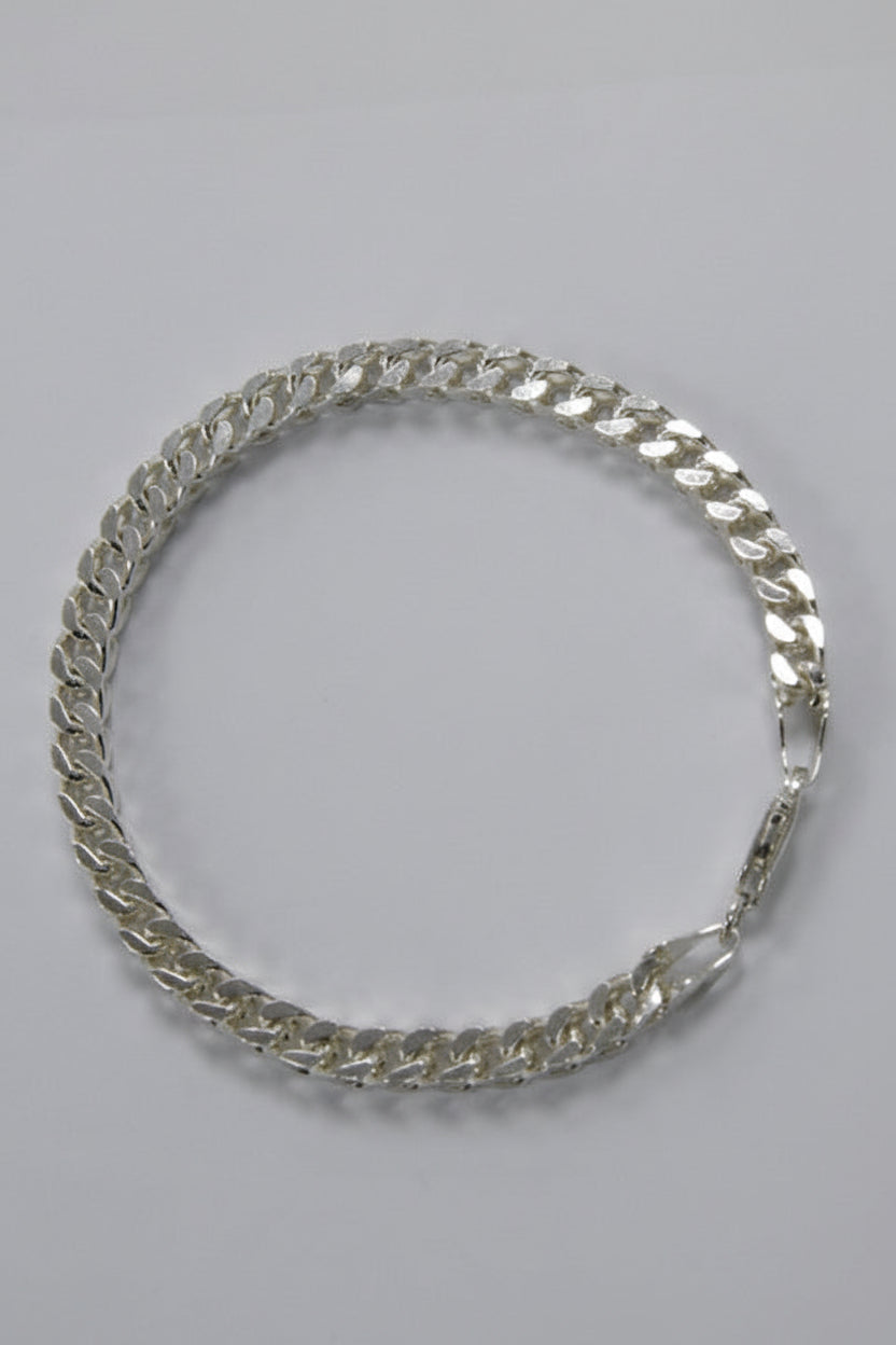 Silver chain necklace on a gray background