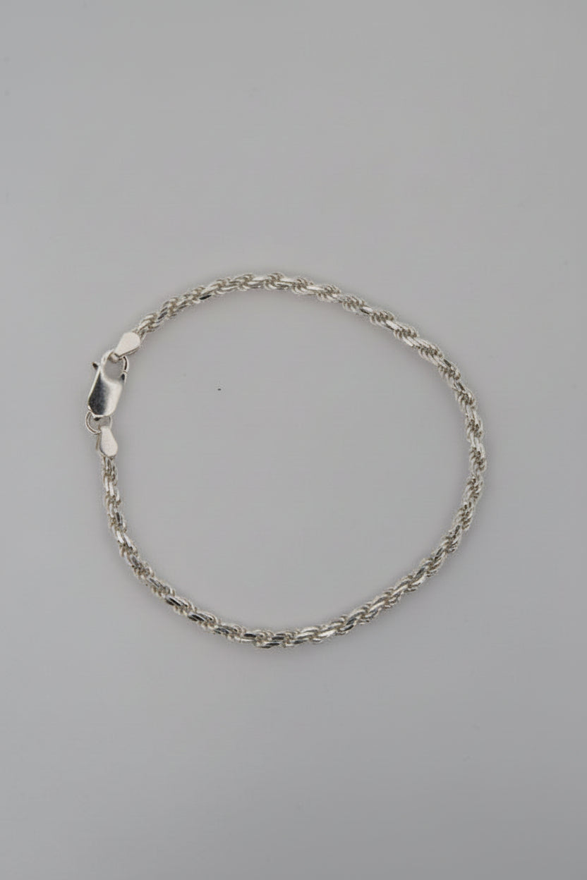 Silver bracelet on a gray background