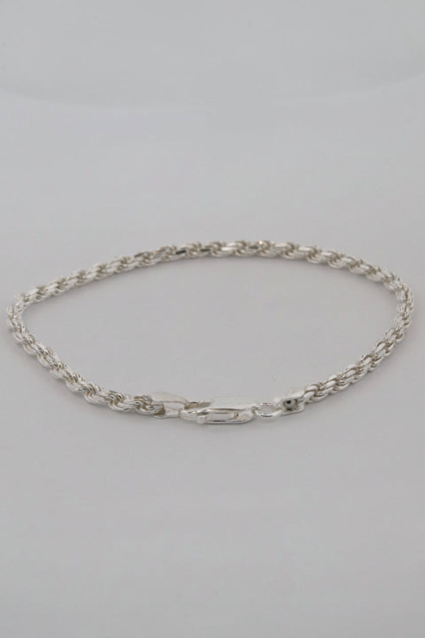 Silver chain necklace on a gray background