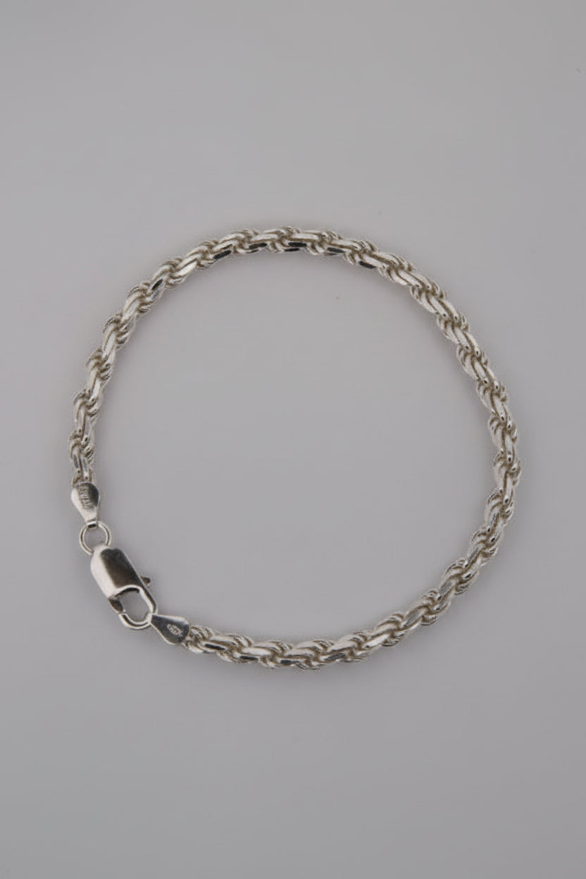 Silver chain bracelet on a gray background