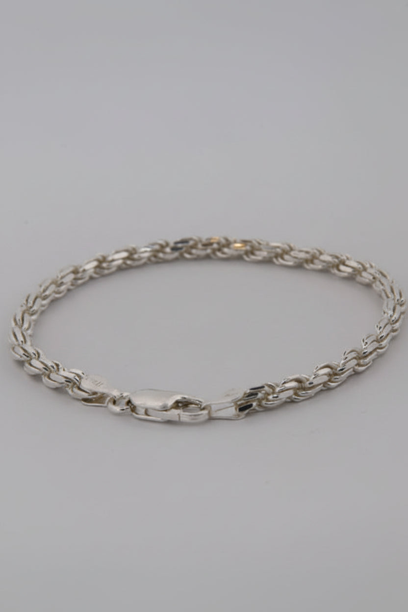 Silver chain bracelet on a light gray background