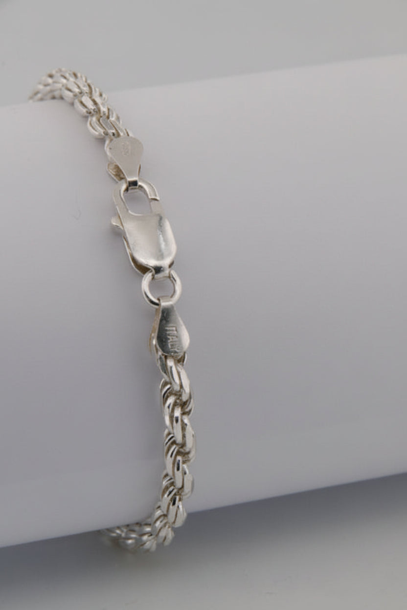 Silver chain bracelet on a gray background