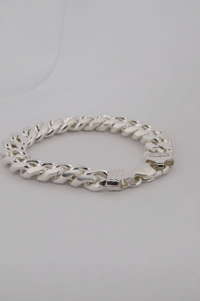 Silver chain bracelet on a light gray background