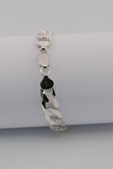 Silver bracelet with a heart charm on a white background