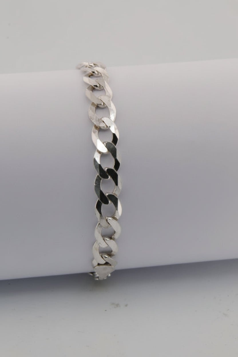 Silver chain bracelet on a white cylindrical stand
