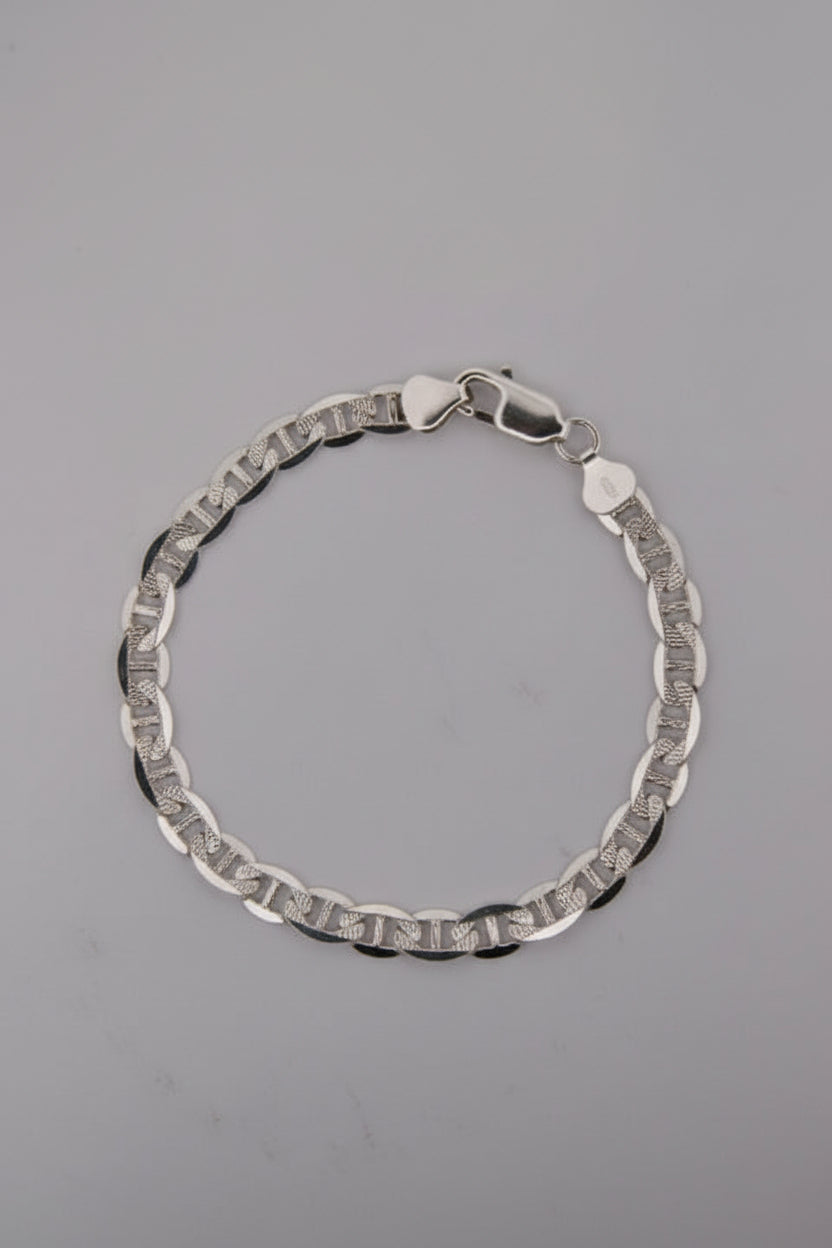 Silver bracelet on a gray background