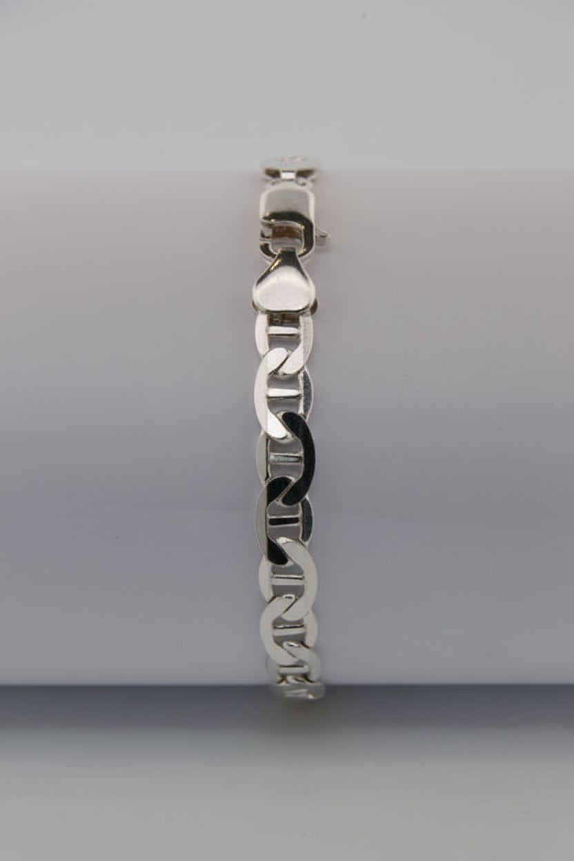Silver bracelet on a white cylindrical object