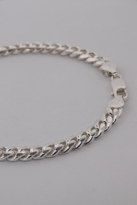 Silver chain necklace on a gray background