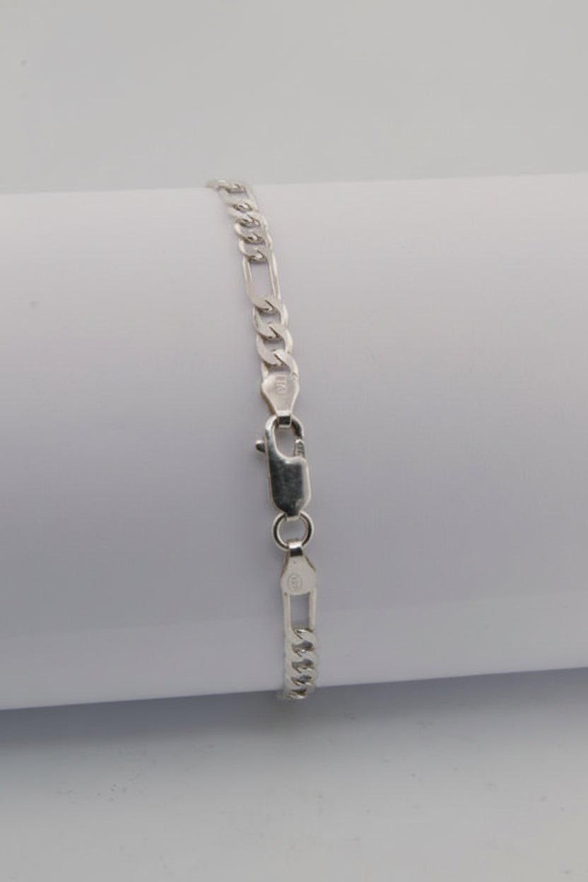 Silver bracelet on a light gray background