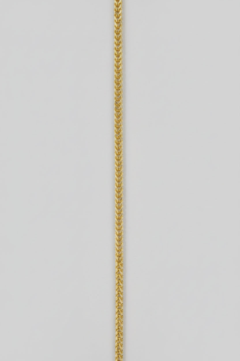 Gold chain on a light gray background
