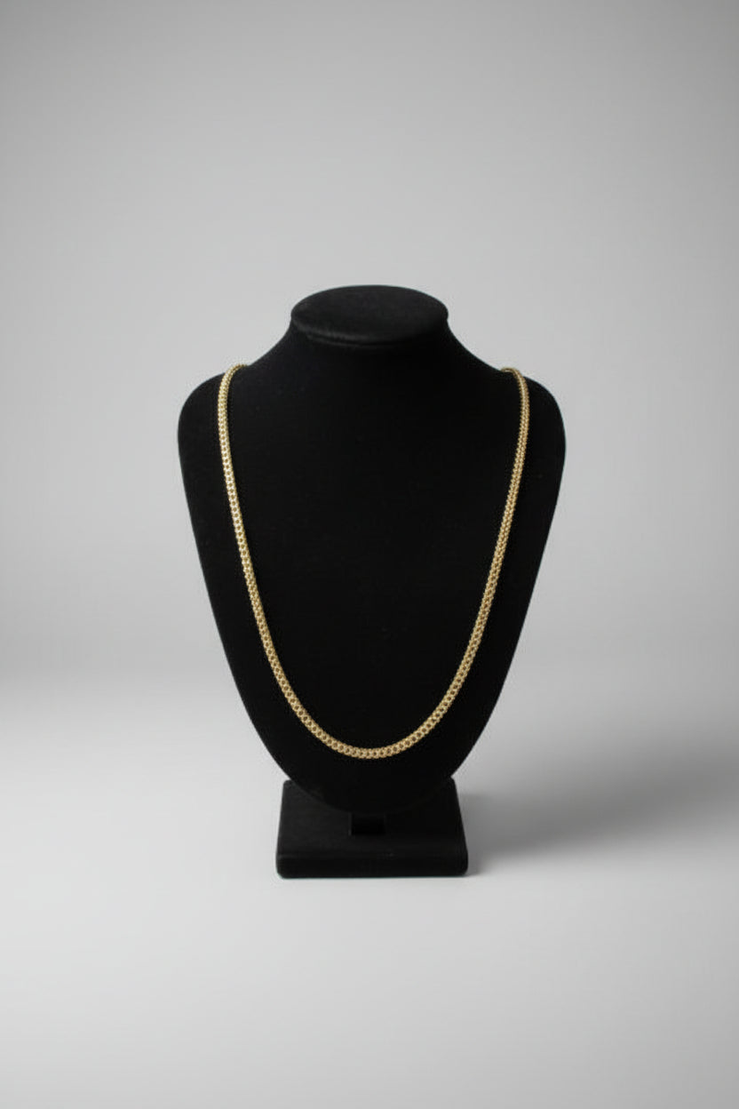 Black hat with gold trim on a marble surface