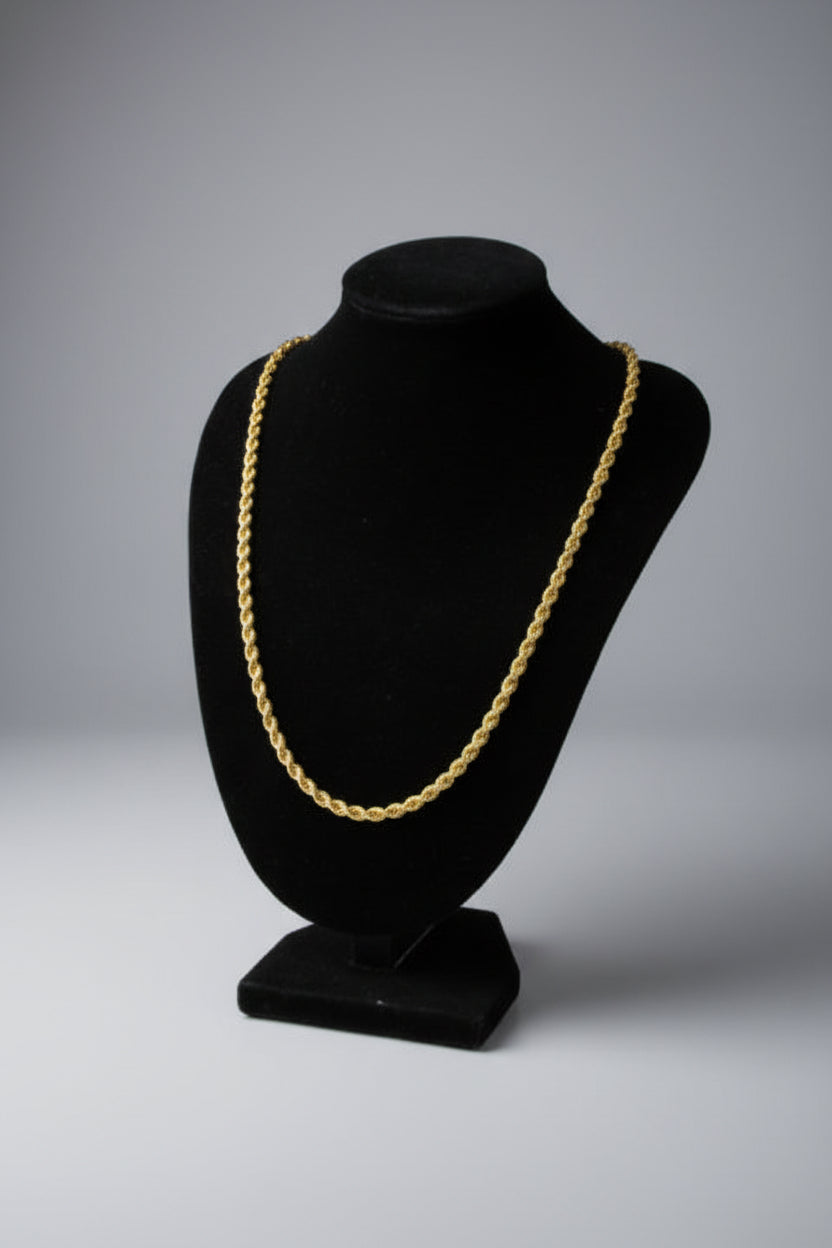 Black hat with a gold chain on a marble surface