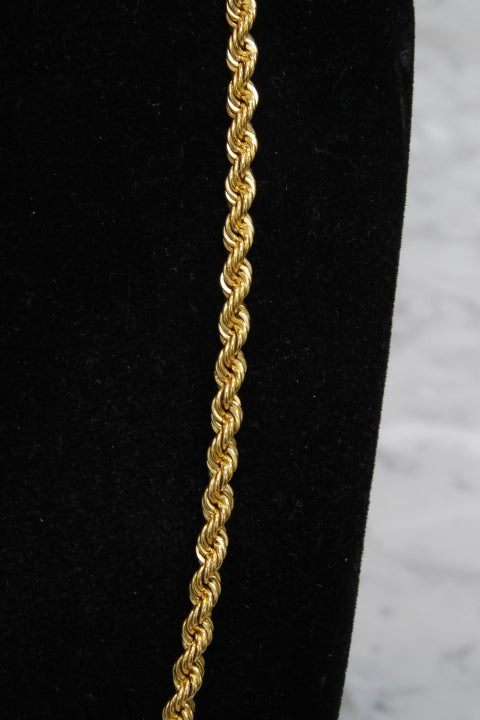 Gold rope chain on a black and white background