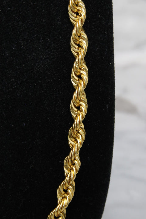 Gold rope chain on a black and white background