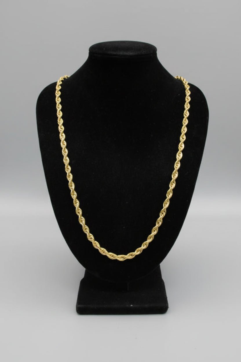 Black hat with a gold chain on a white background