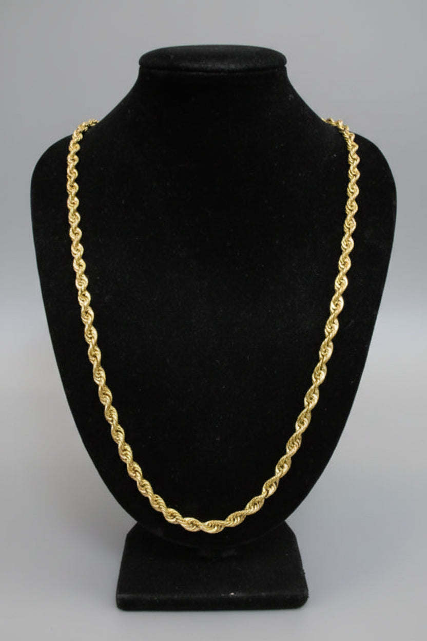 Black hat with a gold chain on a white background
