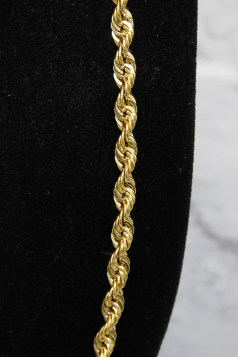 Gold rope chain on a black and white background