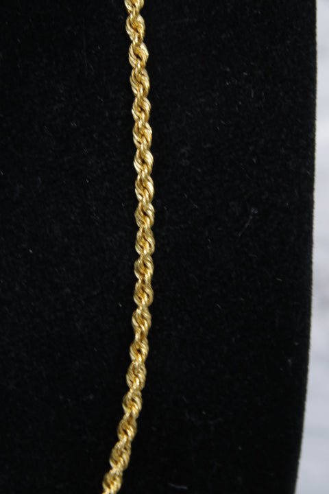 Gold rope chain on a black background