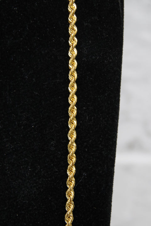 Gold rope chain on a black and white background