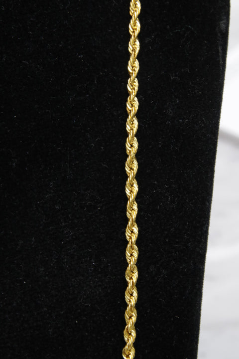 Gold rope chain on a black background