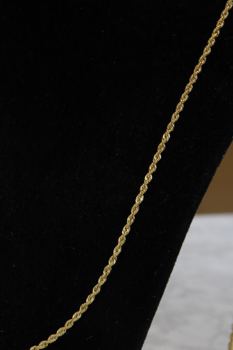 Gold rope chain on a black background