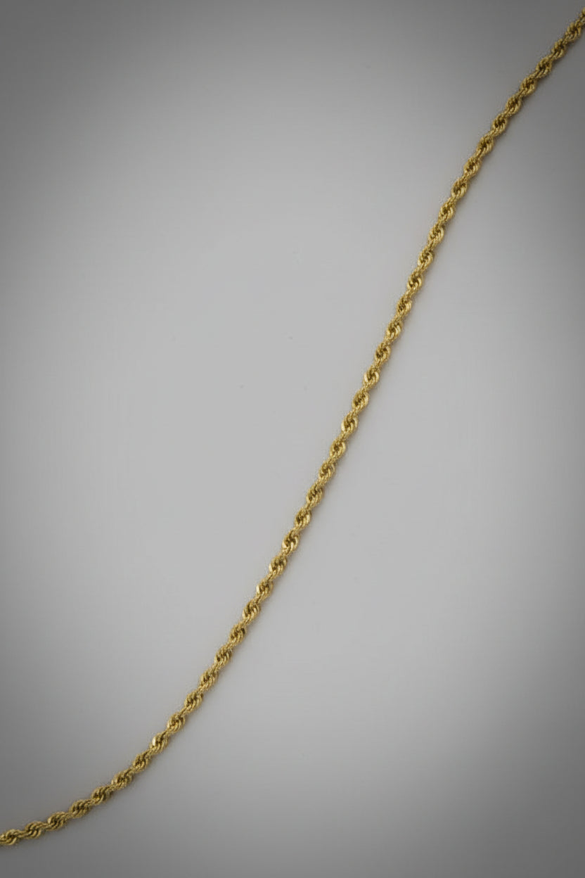 Gold rope chain on a black background