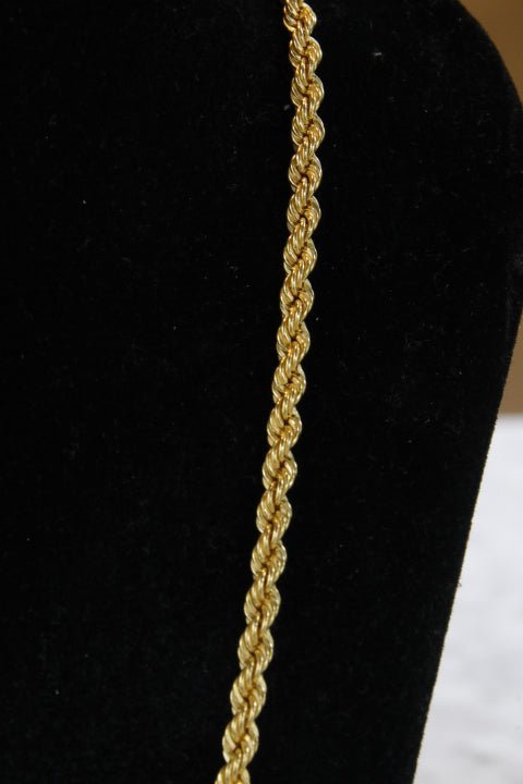 Gold rope chain on a black background