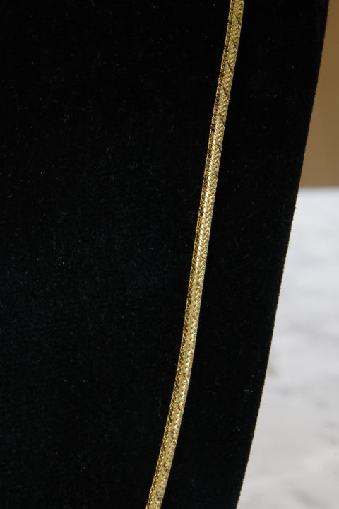 Close-up of a gold cord on black fabric