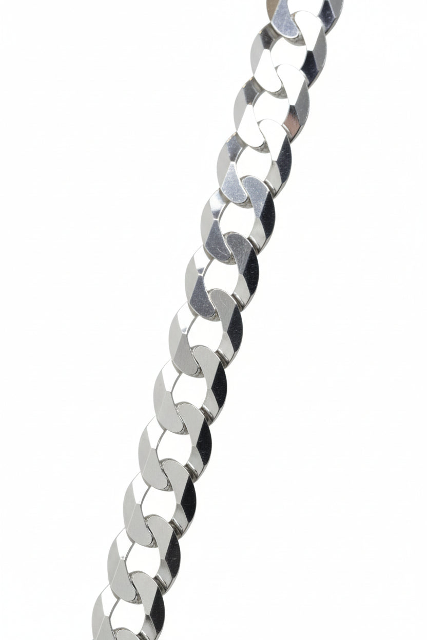 Silver chain bracelet on a black stand with a blurred background