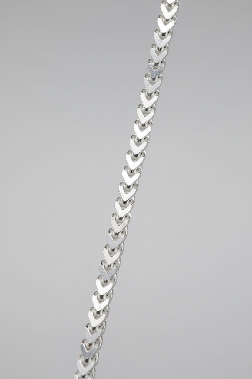 Silver chain necklace on a black background