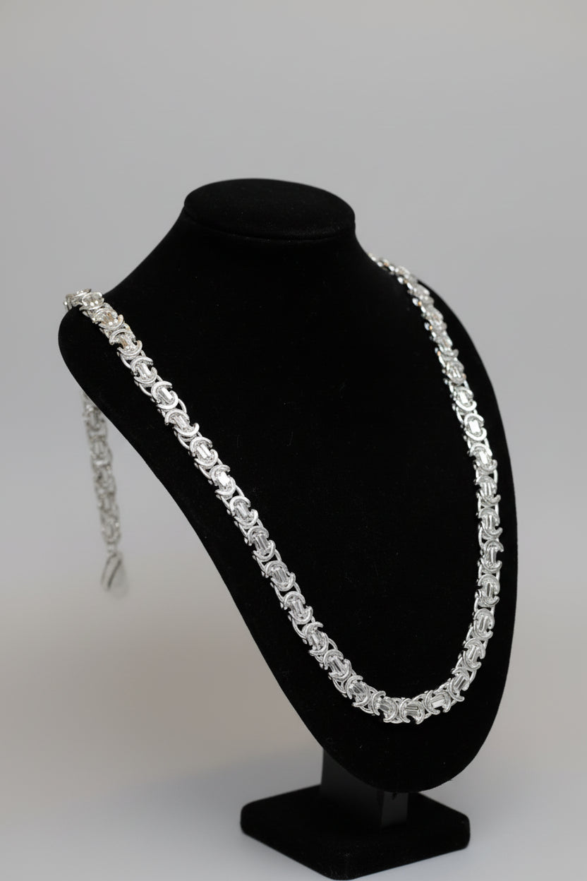 Diamond necklace on a black stand with a blurred background
