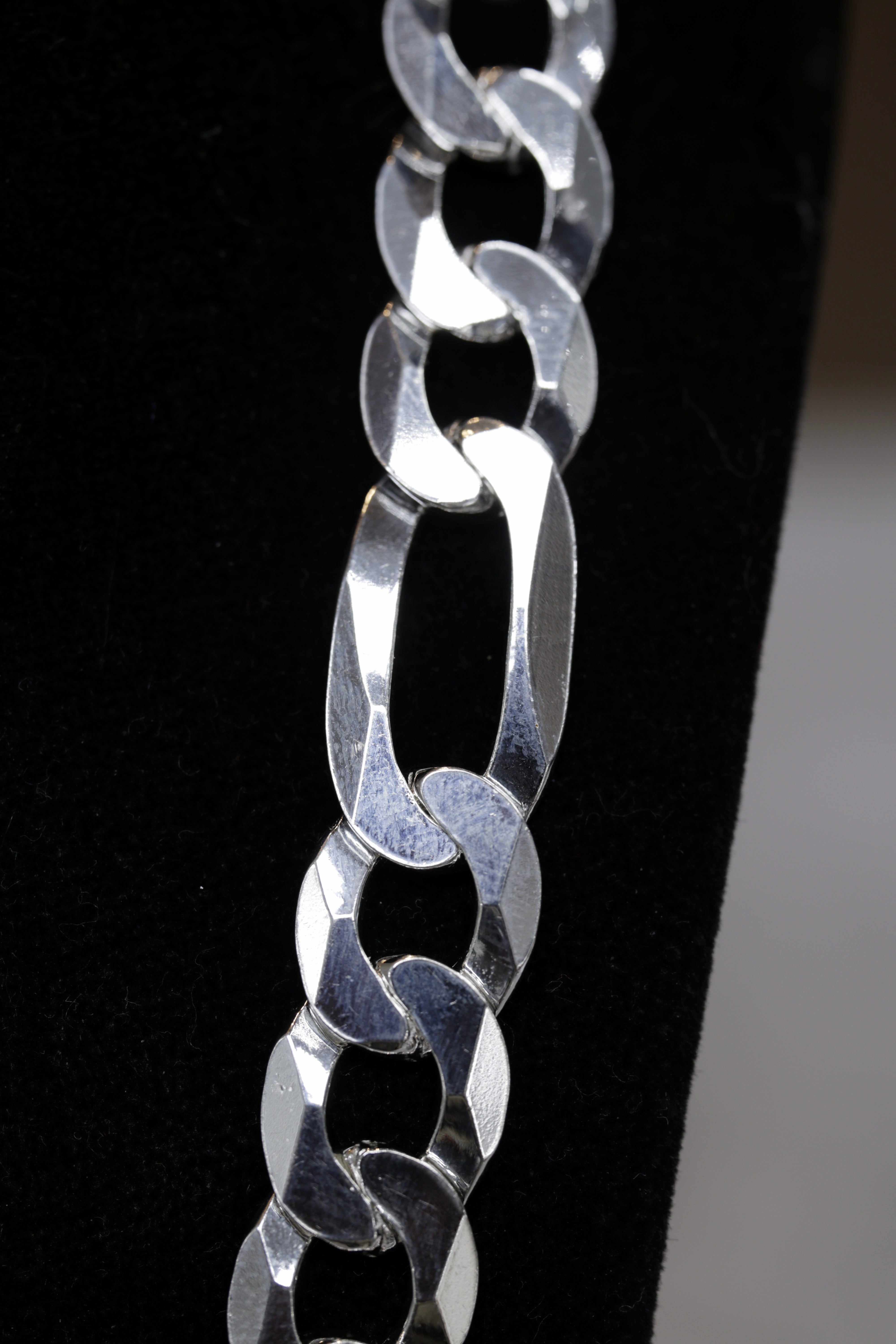 Close-up of a silver chain on a black background