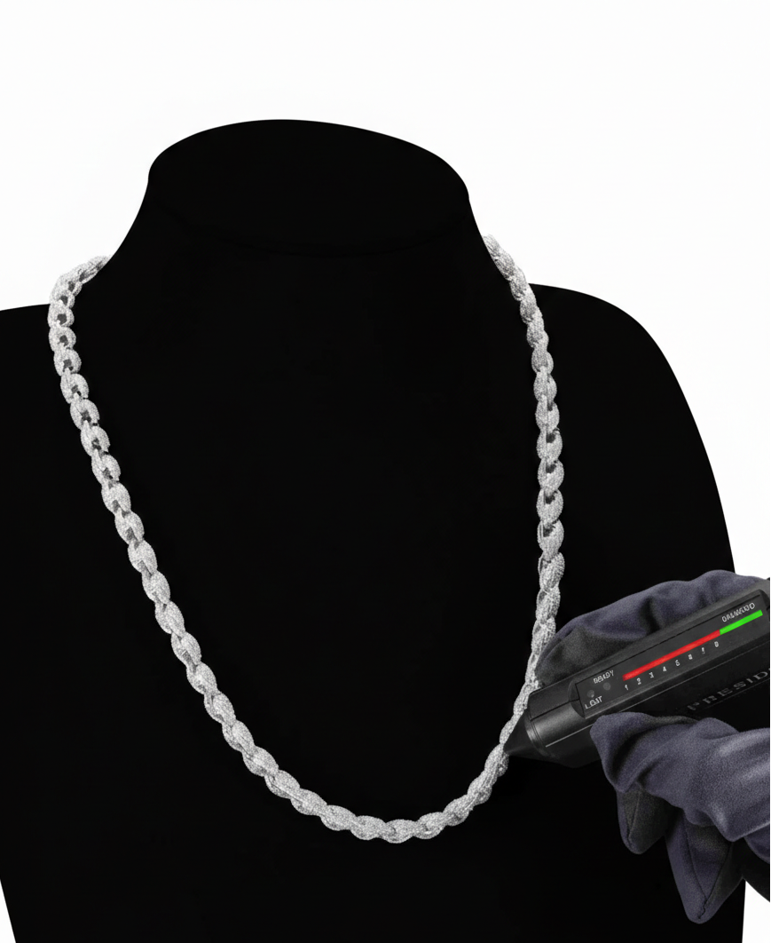 White chain necklace on a black mannequin with a digital scale in the background