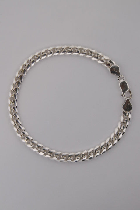 Silver chain bracelet on a gray background