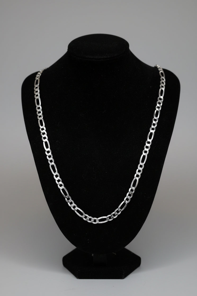 Silver chain necklace on a black mannequin bust.