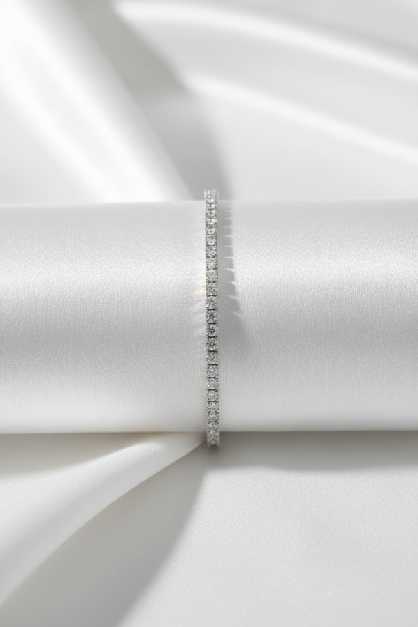 Silver bracelet on a white fabric background