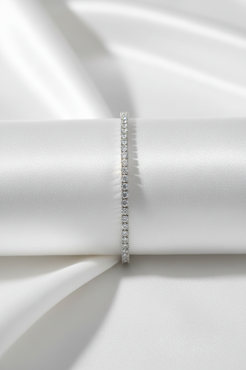Silver bracelet on a white fabric background