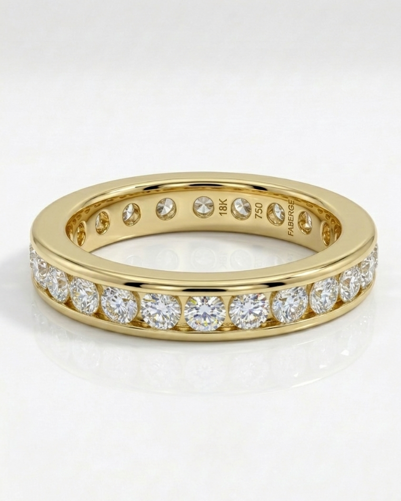 Gold wedding band with diamonds on a white background