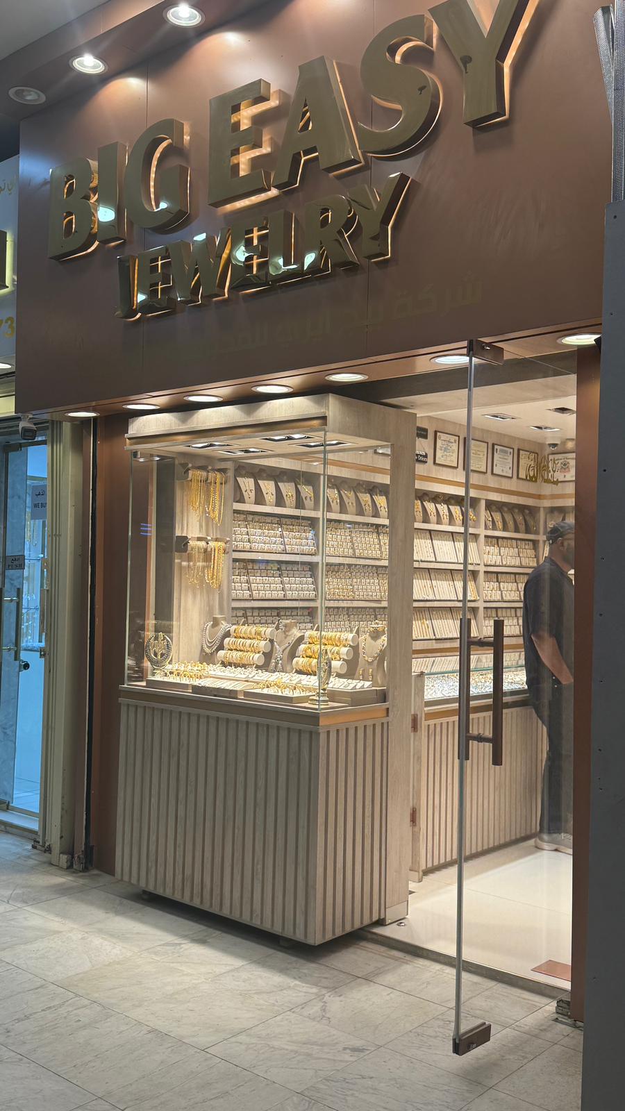 Storefront of Big Easy Jewelry with glass display case and interior view.
