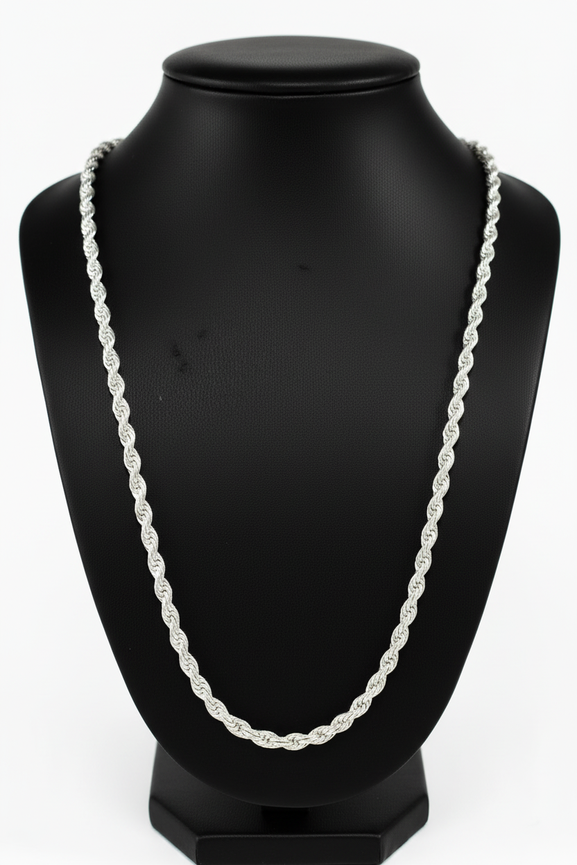 Silver chain necklace on a black mannequin bust against a white background